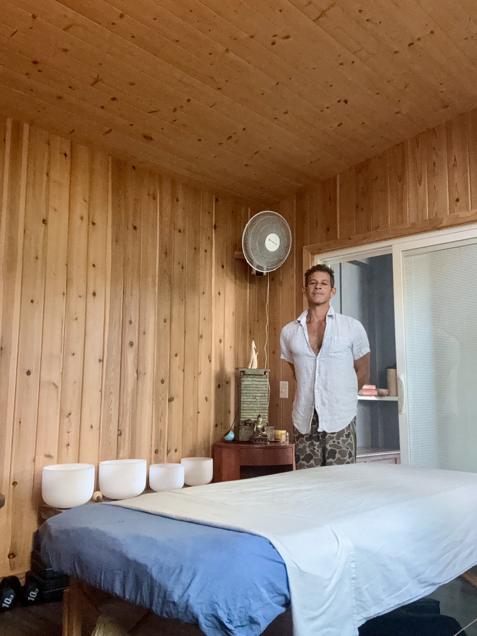The studio in Papaikou, Big Island — a quiet wooden space with crystal singing bowls and massage table